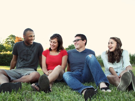 group of people sitting in the grass