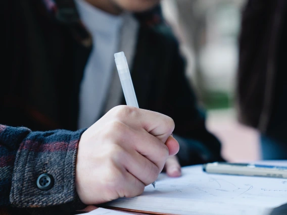 person writing in a notebook