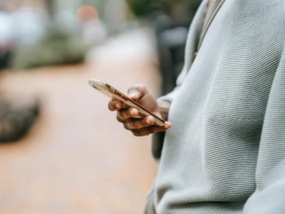 close up view of a person's hands holding a smart phone