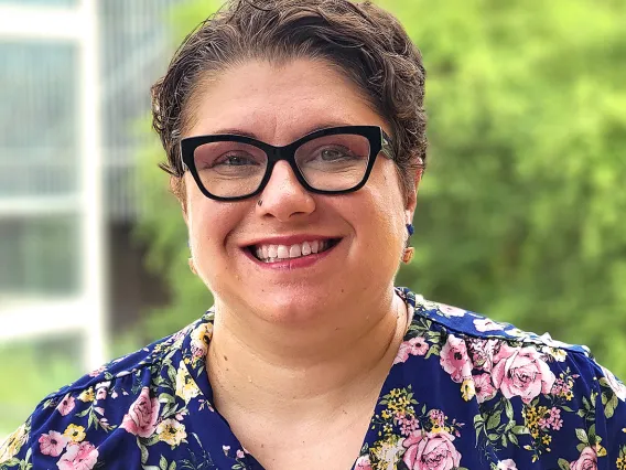 headshot of a person standing outside