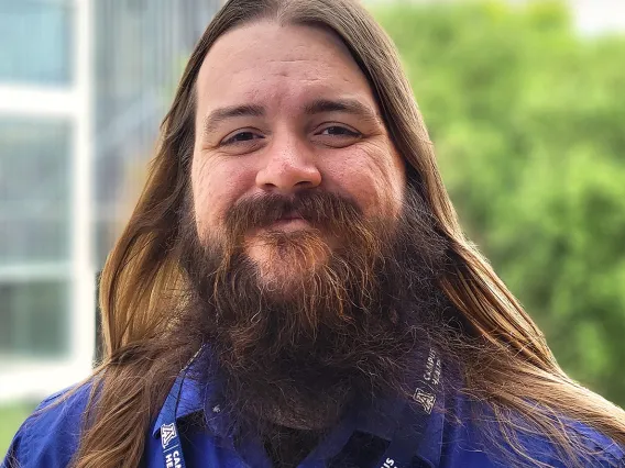 headshot of a person standing outside