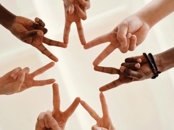 a close up of hands arranged in a circle with fingers touching