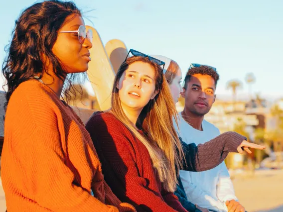 group of people sitting outdoors and talking