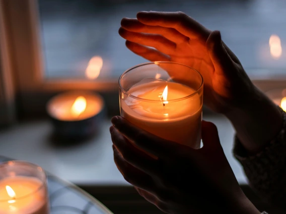 hands holding candle