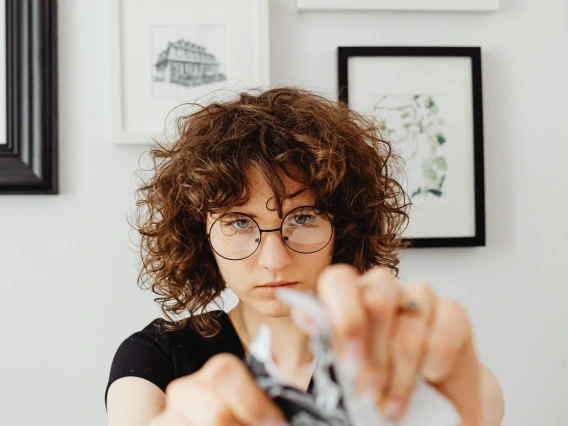 a person tearing a piece of paper in half