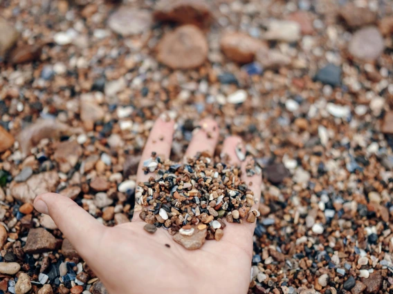 close up of a hand holding sand