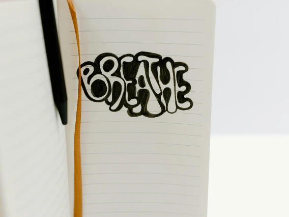 the word breathe written in a notebook