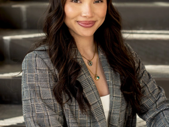 headshot of a person sitting on stairs