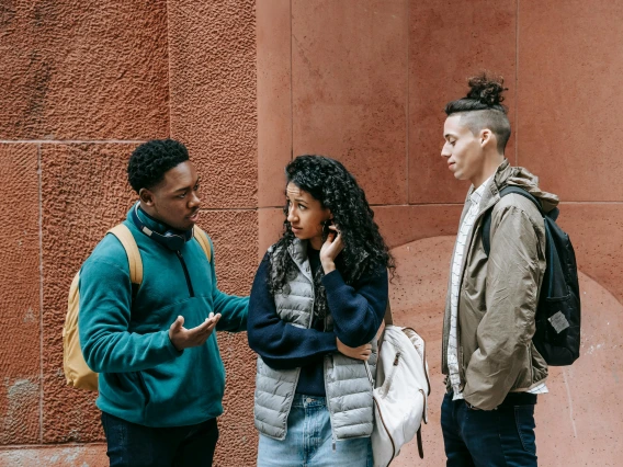 group of people standing outdoors and talking