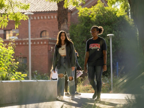 two people walking on a college campus
