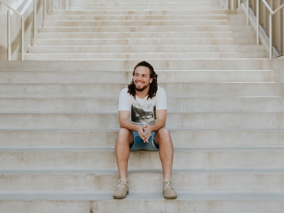 man sitting on the steps to a building