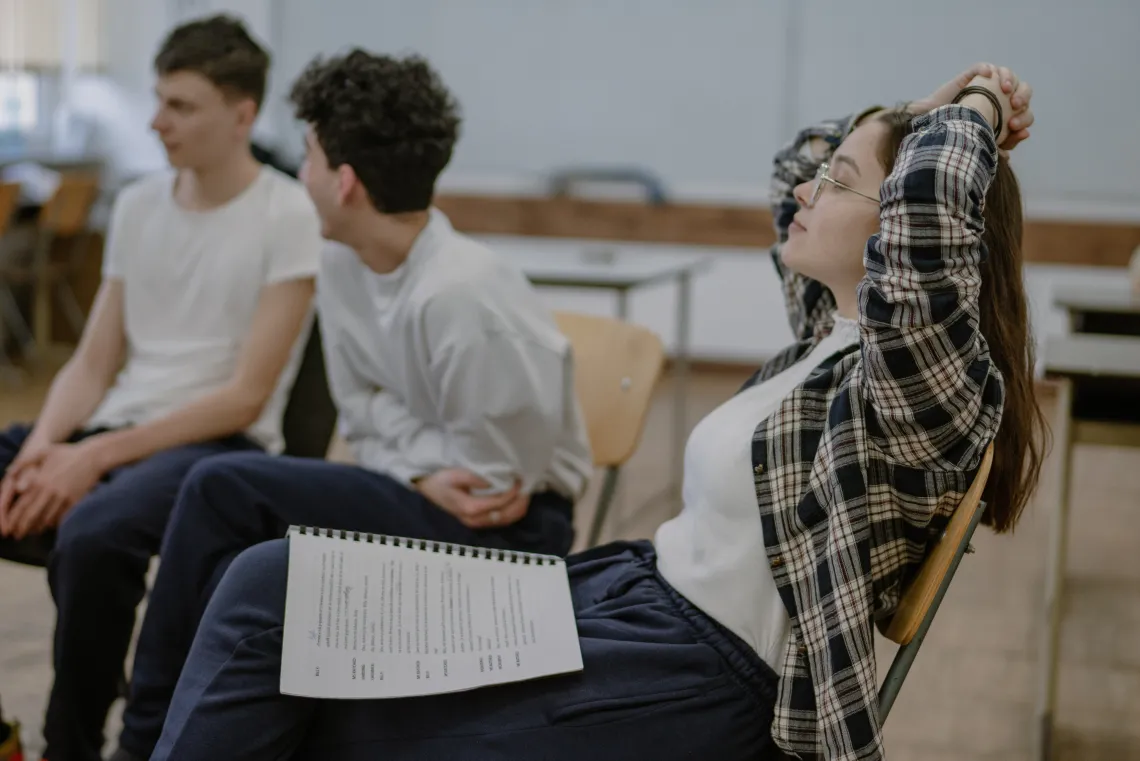 group of students sitting in chairs and talking