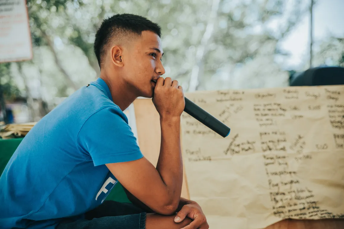 person speaking into a microphone