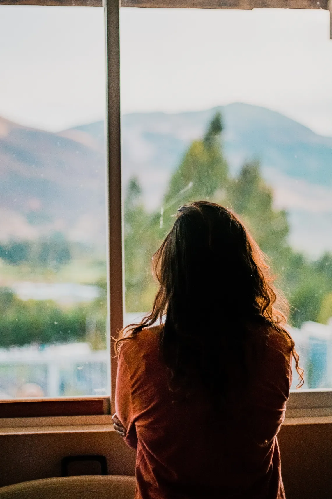 a person looking out the window seen from behind