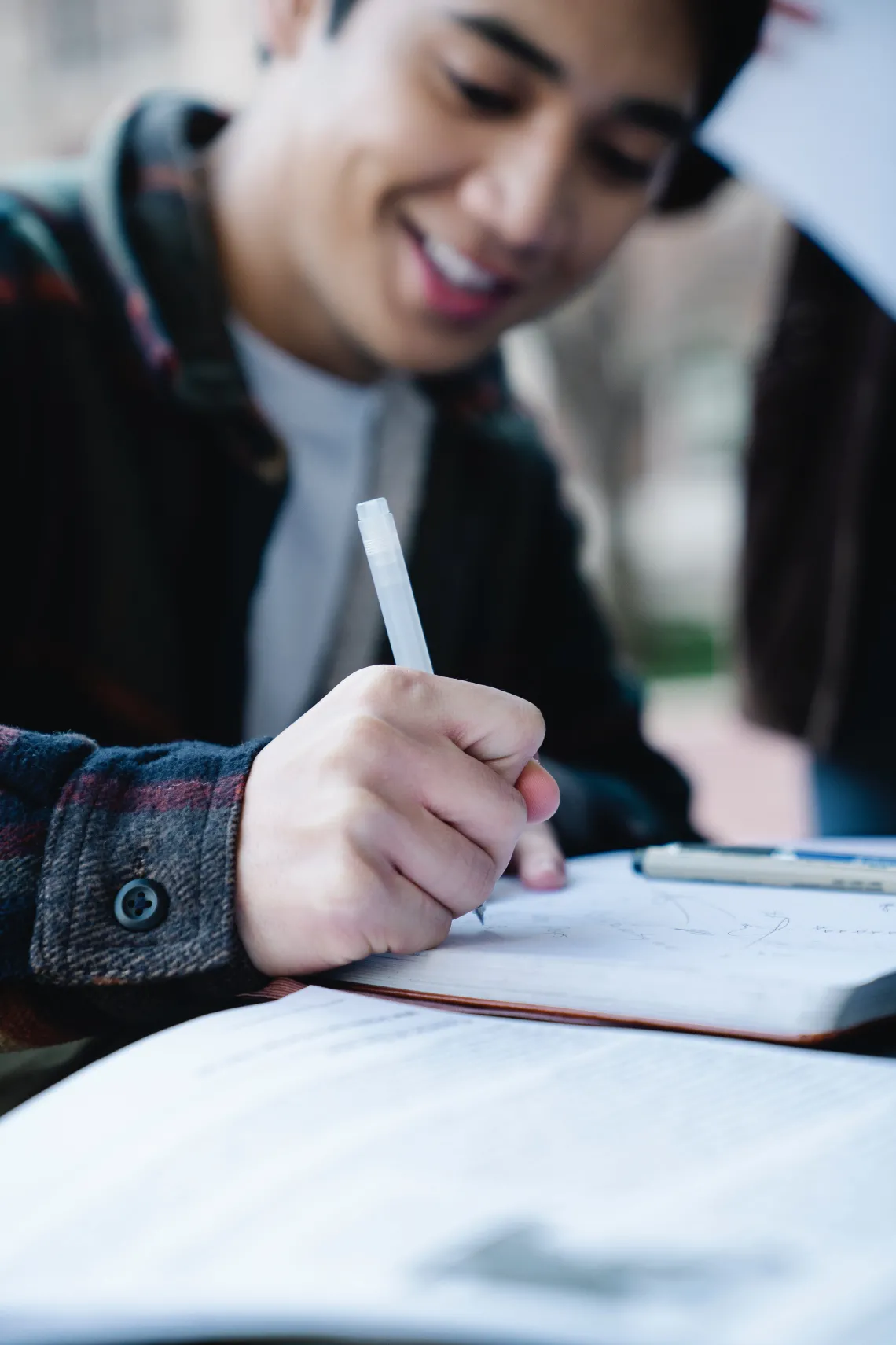 person writing in a notebook