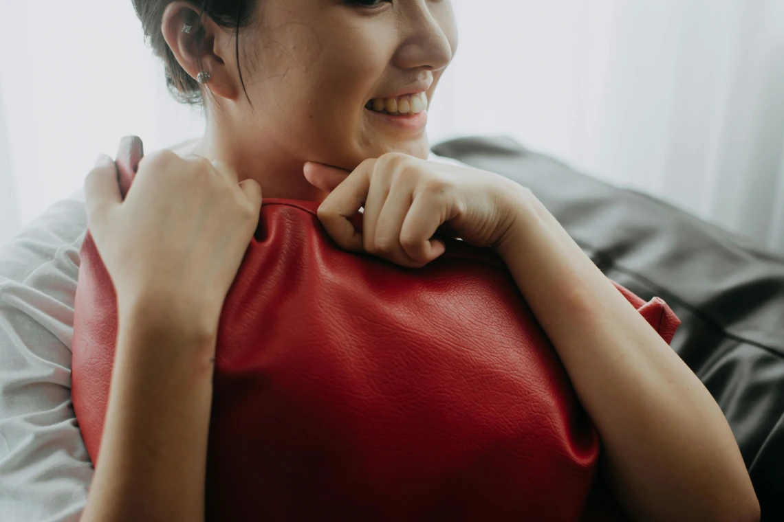 photograph of a person hugging a pillow