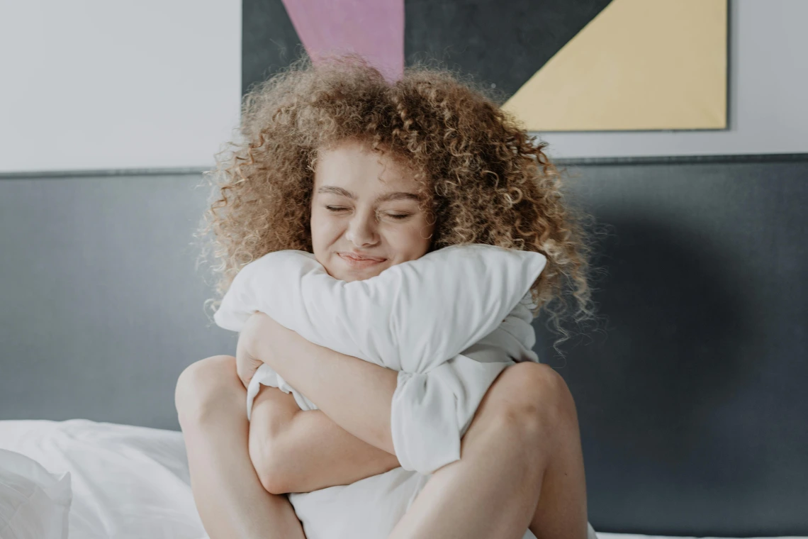 person hugging a pillow