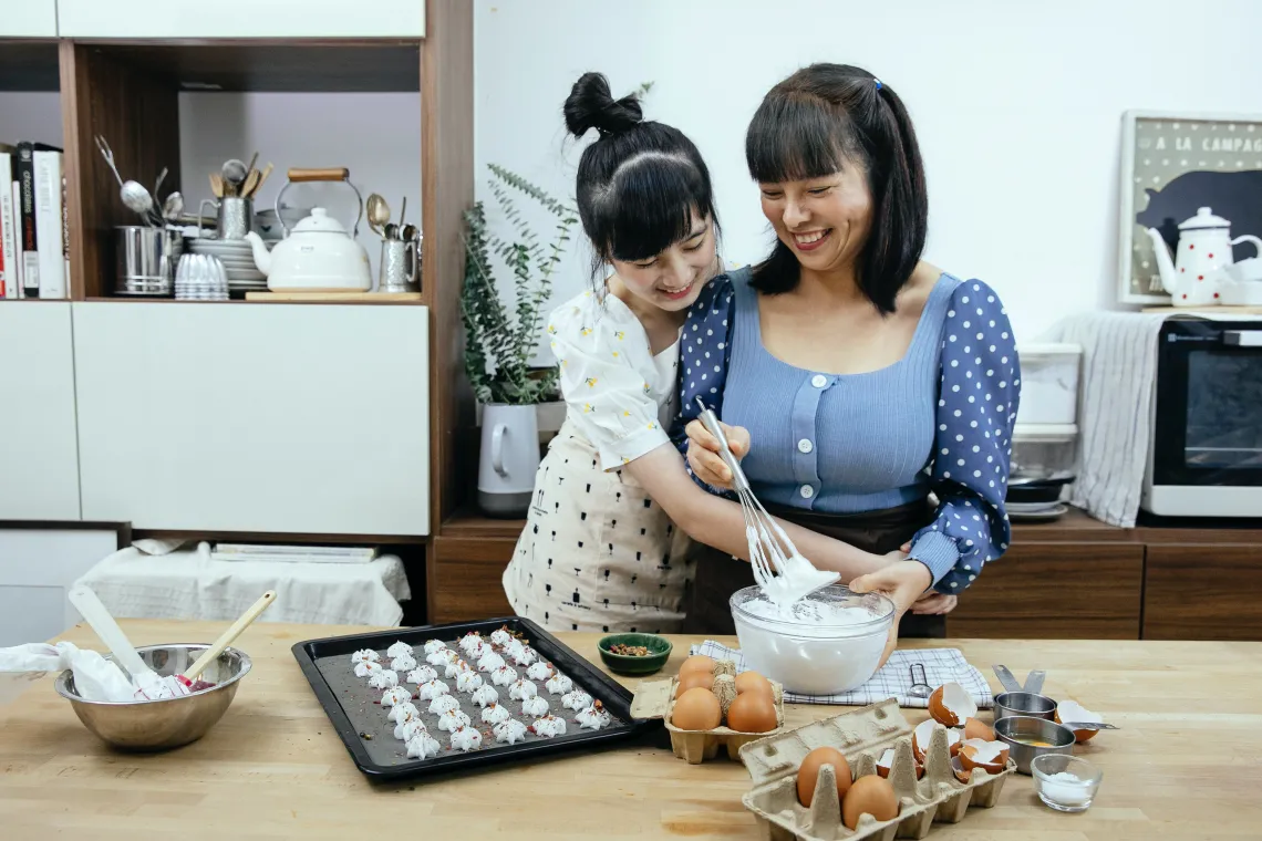 Mother and daughter baking together