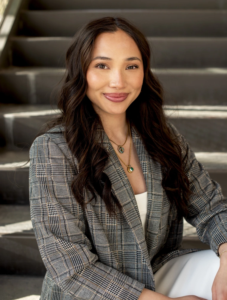 headshot of a person sitting on stairs