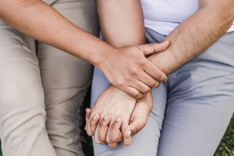 Two people holding hands