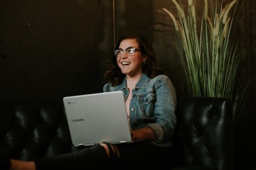woman with a laptop on a couch